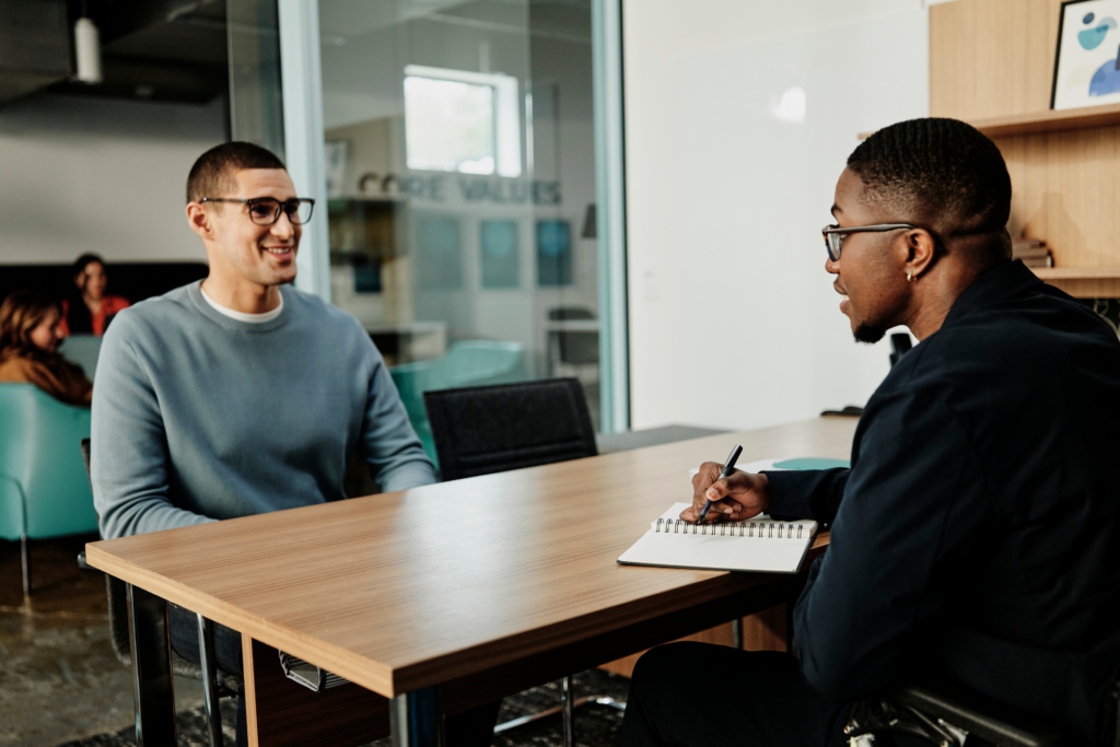 Hiring manager interviews candidate in his office.