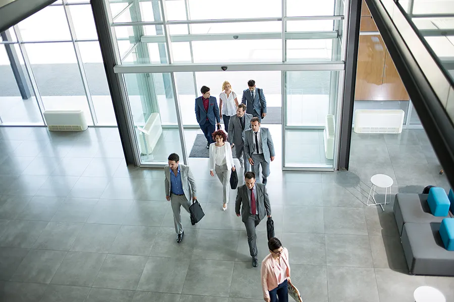 Group of professional business people walking on the way in building