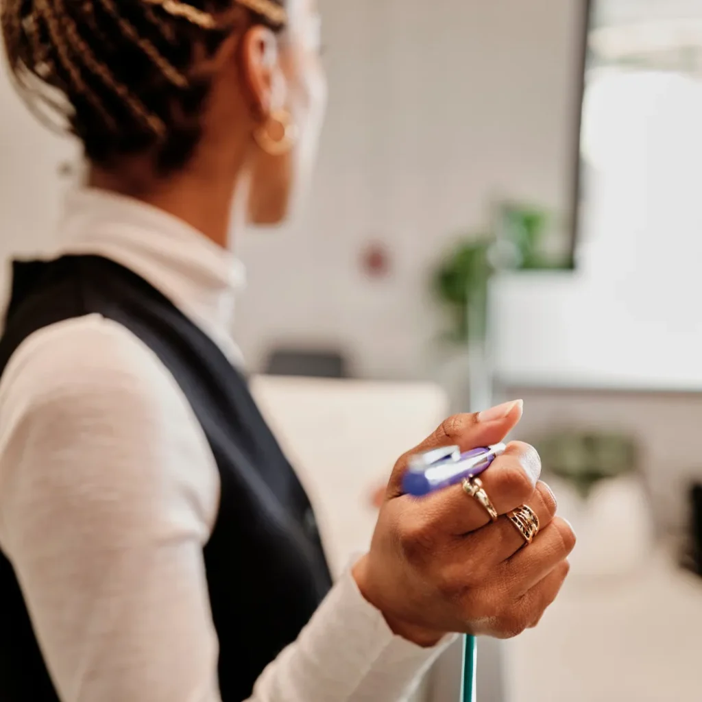 Close-up of a worker holding a pen in their hand.