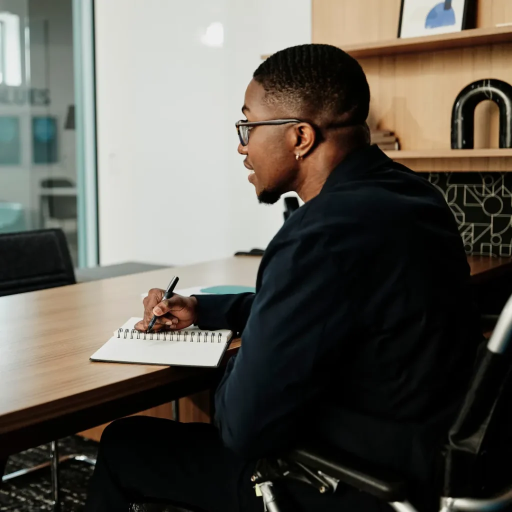 Manager makes notes at his desk during a job interview