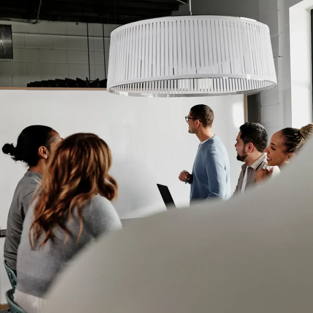 Worker presents at a team meeting.