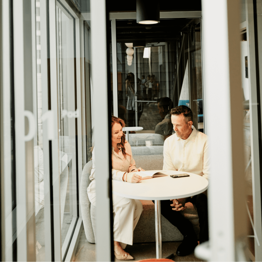 Two colleagues are sitting together in an office.