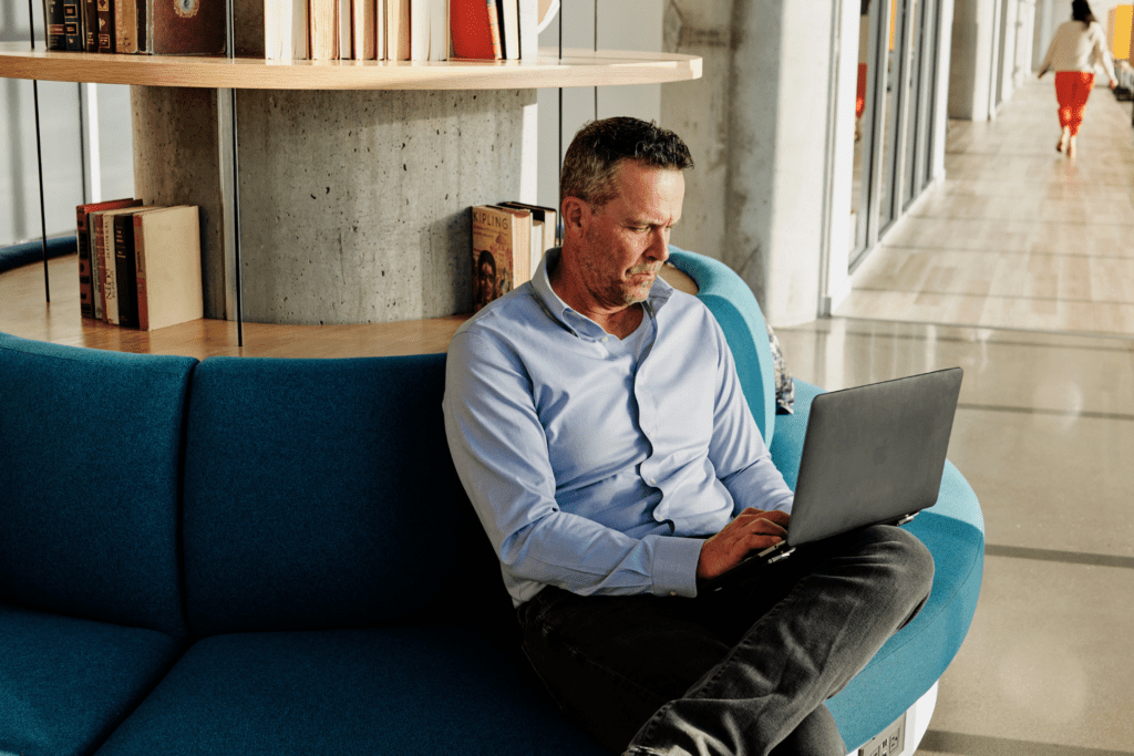 Man works on a laptop in an office