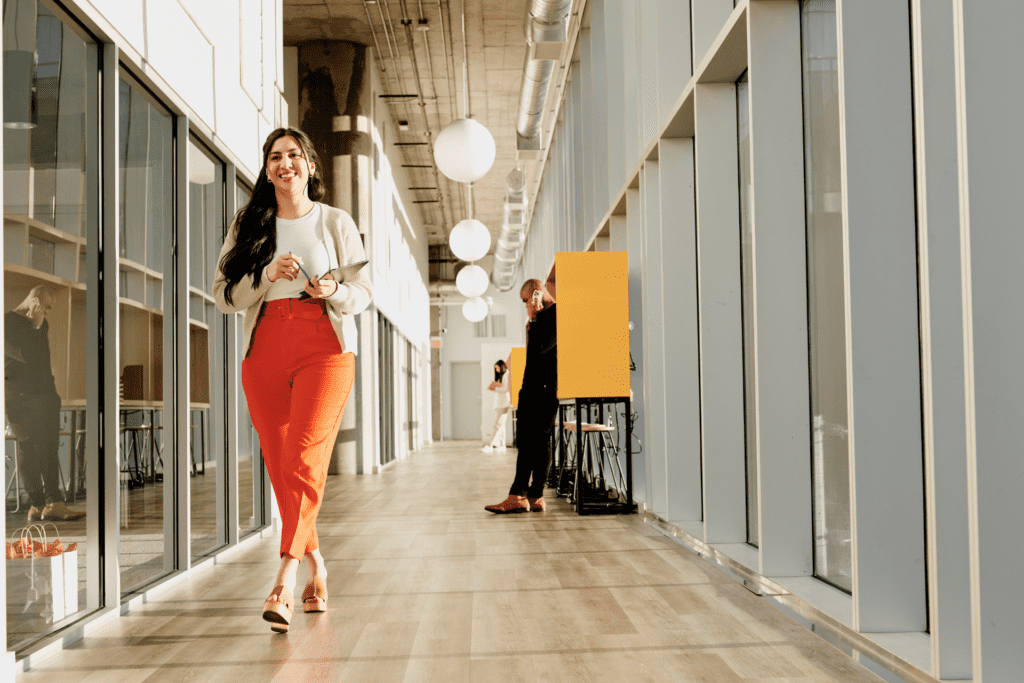Employee walks down a large hallway in a modern office setting