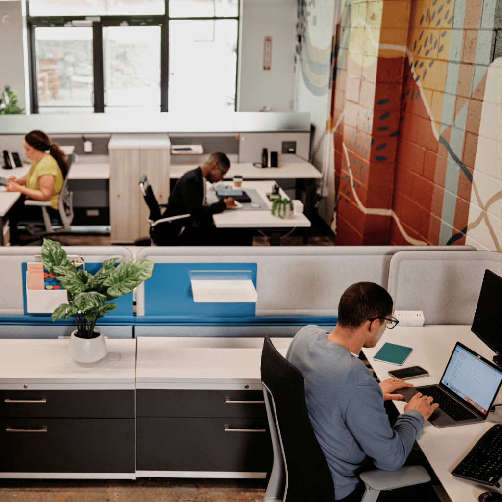 Employees working in cubicle office setting.