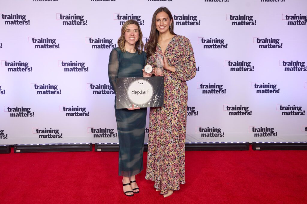 Flannery Kuhn and Paige Harroff with Dexian's 2025 APEX Training Award on the awards red carpet.