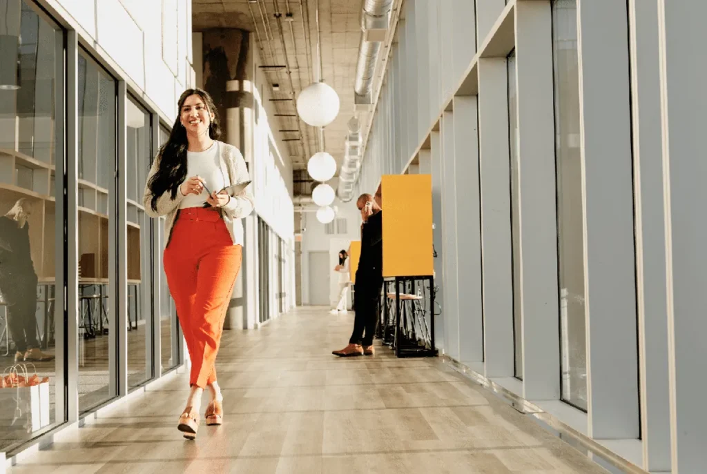 Employee walks down a large hallway in a modern office setting