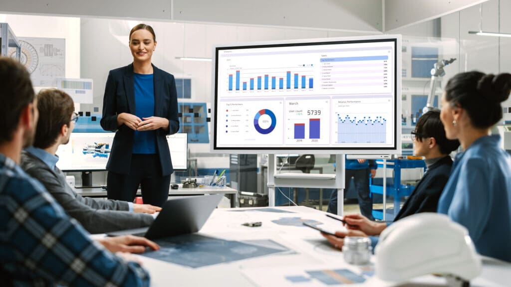 Woman presenting graphics to the team